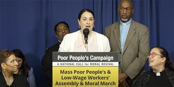 Rev. Dr. Liz Theoharis standing at podium speaking at the Poor People's Campaign