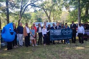 Project partners, Benton Harbor city officials, and residents celebrate the Ox Creek restoration efforts. Credit: Zaire Williams/Benton Spirit News