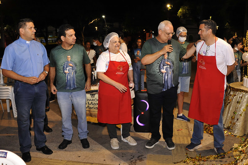 Foto colorida mostra várias pessoas em pé durante evento na Praça Deodoro, no Centro de São Luís. O representante da Paróquia Andrey Barreto fala ao microfone.