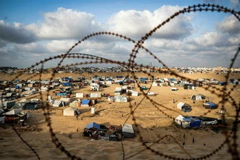 Tents housing displaced Palestinians are pictured behind barbed wire in Rafah in the southern Gaza Strip on April 30, 2024.