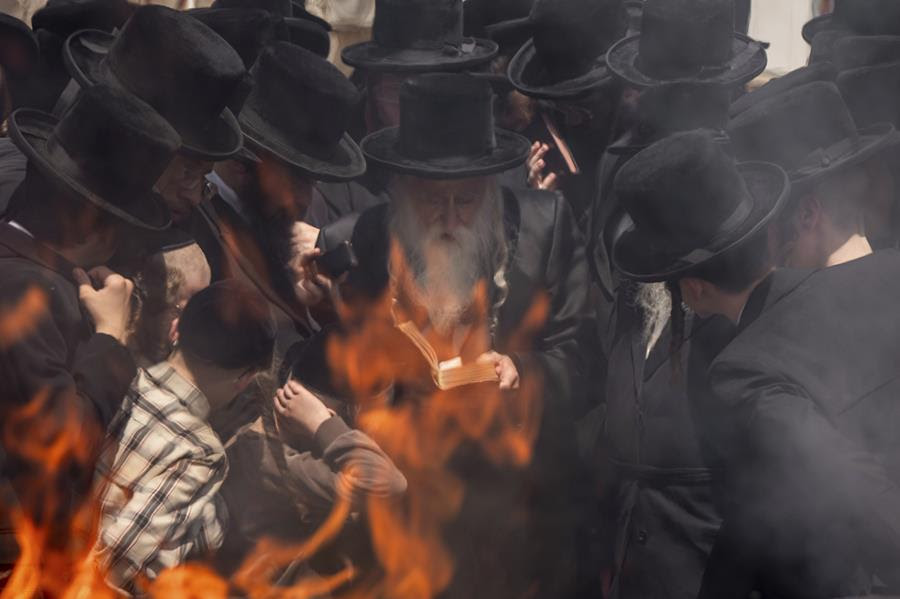 Ultra-Orthodox Jews gather together to prepare for Passover and burn leavened items.
