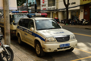 Two police vehicles are parked along a curb.