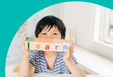 Young child with letter blocks spelling learn