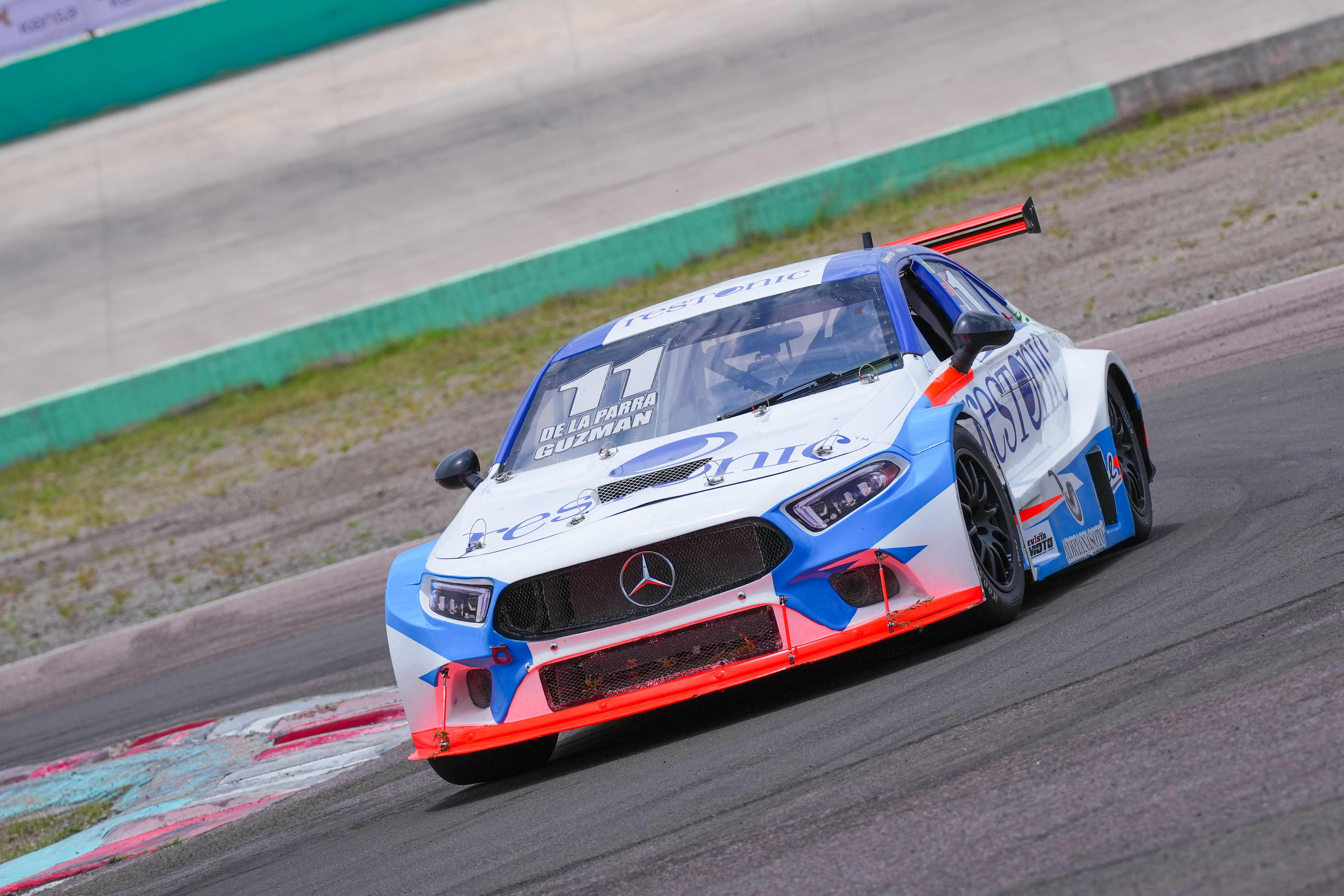 a man standing in front of a race car