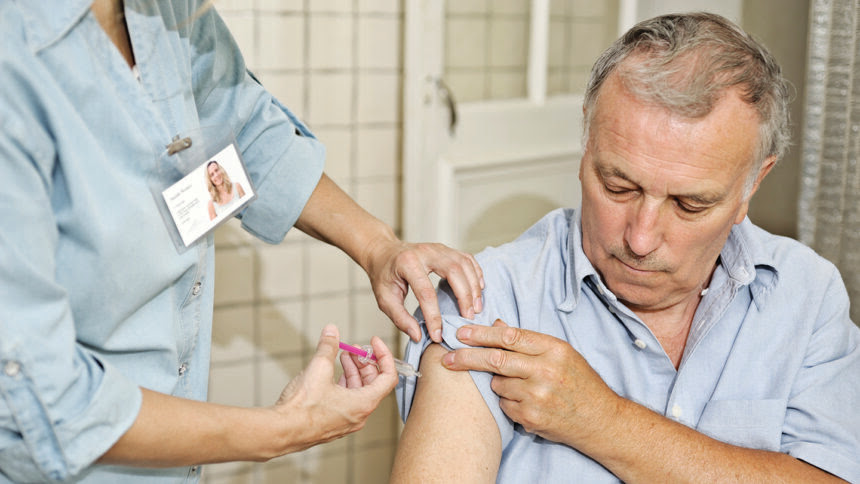 Clinician gives man vaccine