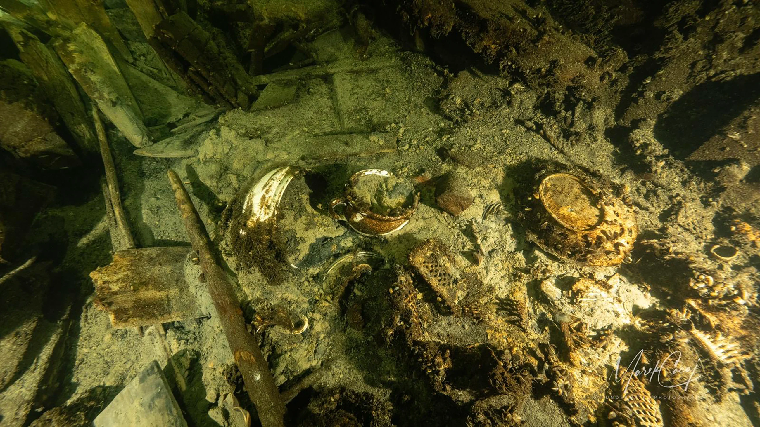 Porcelain items in a 19th century sailing ship wreckage that a team of Polish divers discovered on July 11, 2024, on the Baltic seabed about 37 kilometers (20 nautical miles) south of the Swedish isle of Öland. The ship was loaded ''to the brim'' with luxury goods including porcelain items and about 100 bottles of Champagne and mineral water and rests about 58 meters (190 feet) deep in conditions that the Baltictech divers say have preserved it ''wonderfully.'' (Tomasz Stachura/Baltictech via AP)