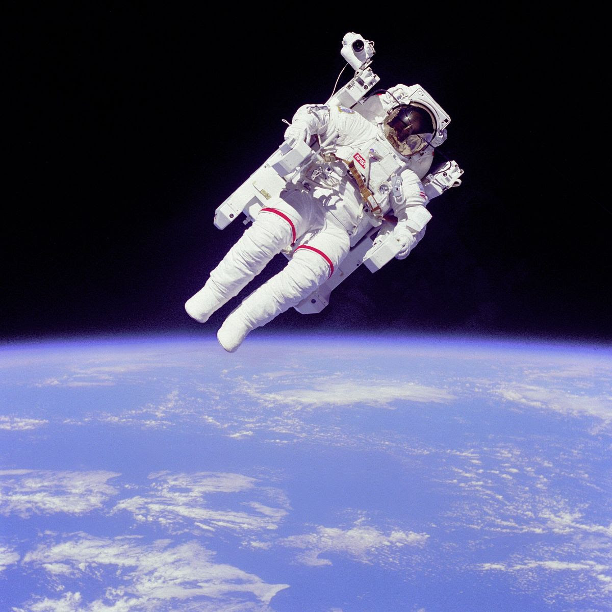 close up of astronaut floating above the Earth