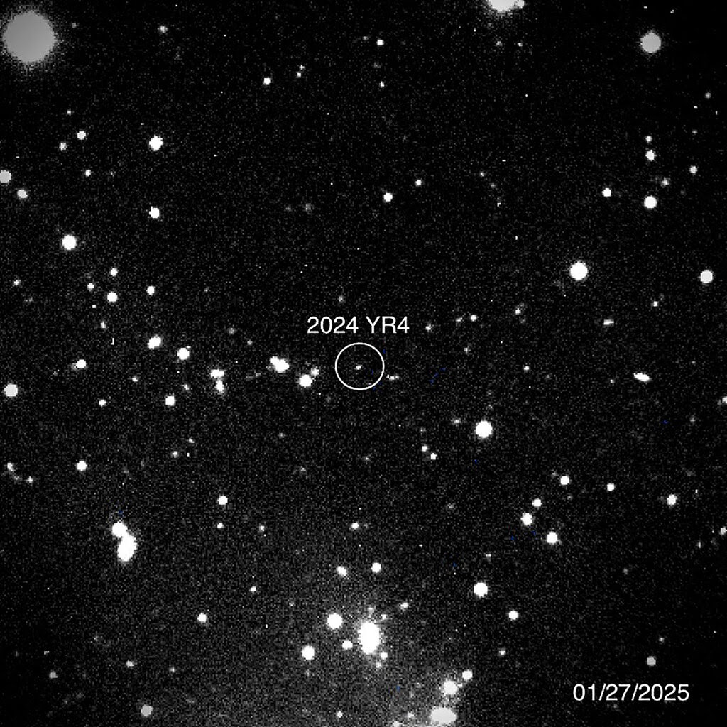 A black-and-white telescope image of the asteroid, with a circle drawn around it and a label that reads "2024 YR4."