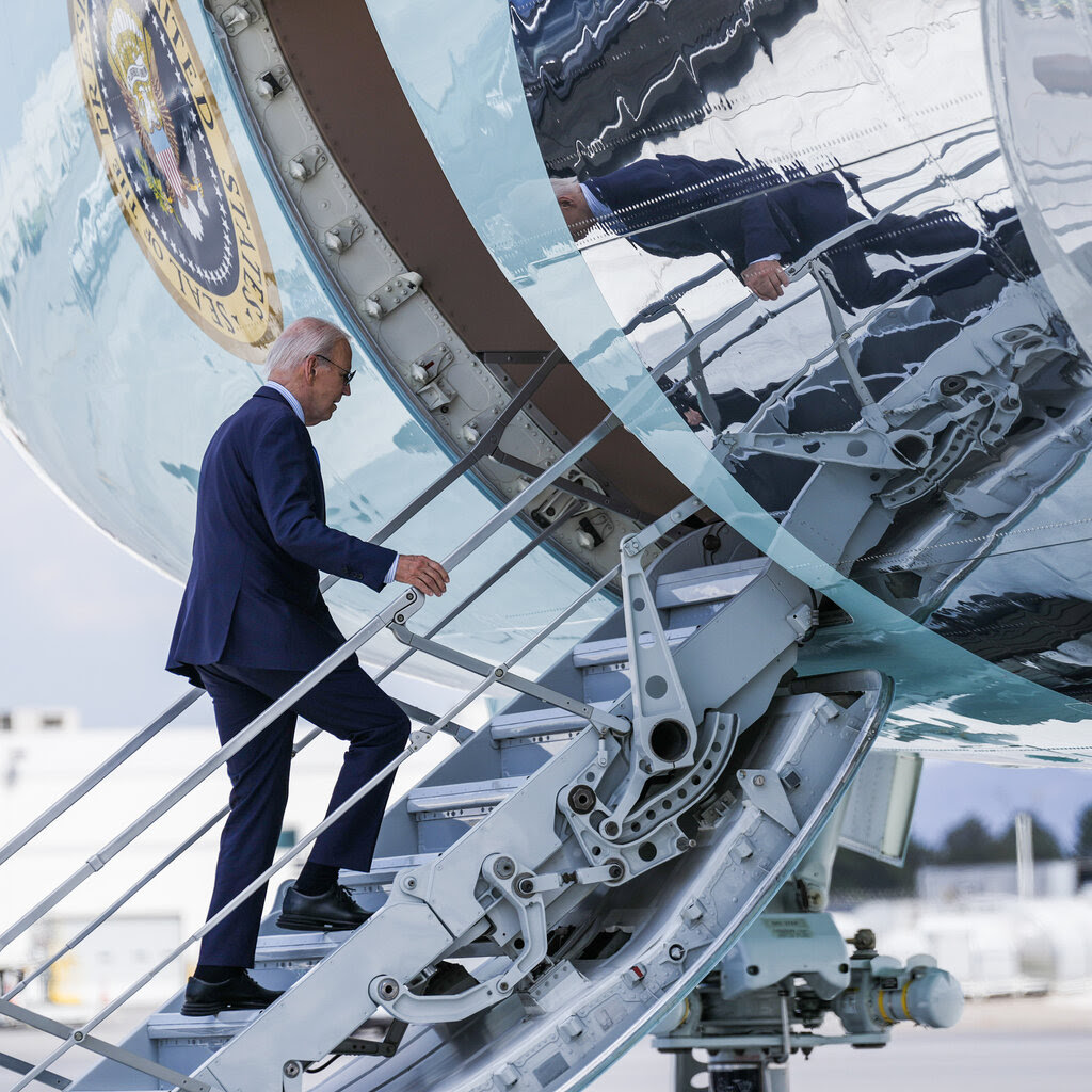 President Biden walking in front of a helicopter at Joint Base Andrews.