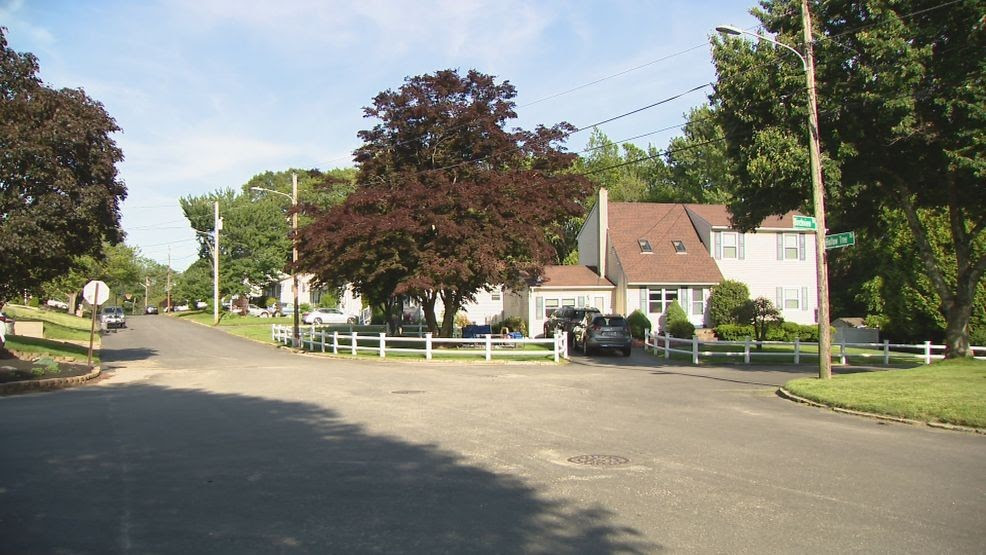Man in critical condition, pinned under car in Cranston