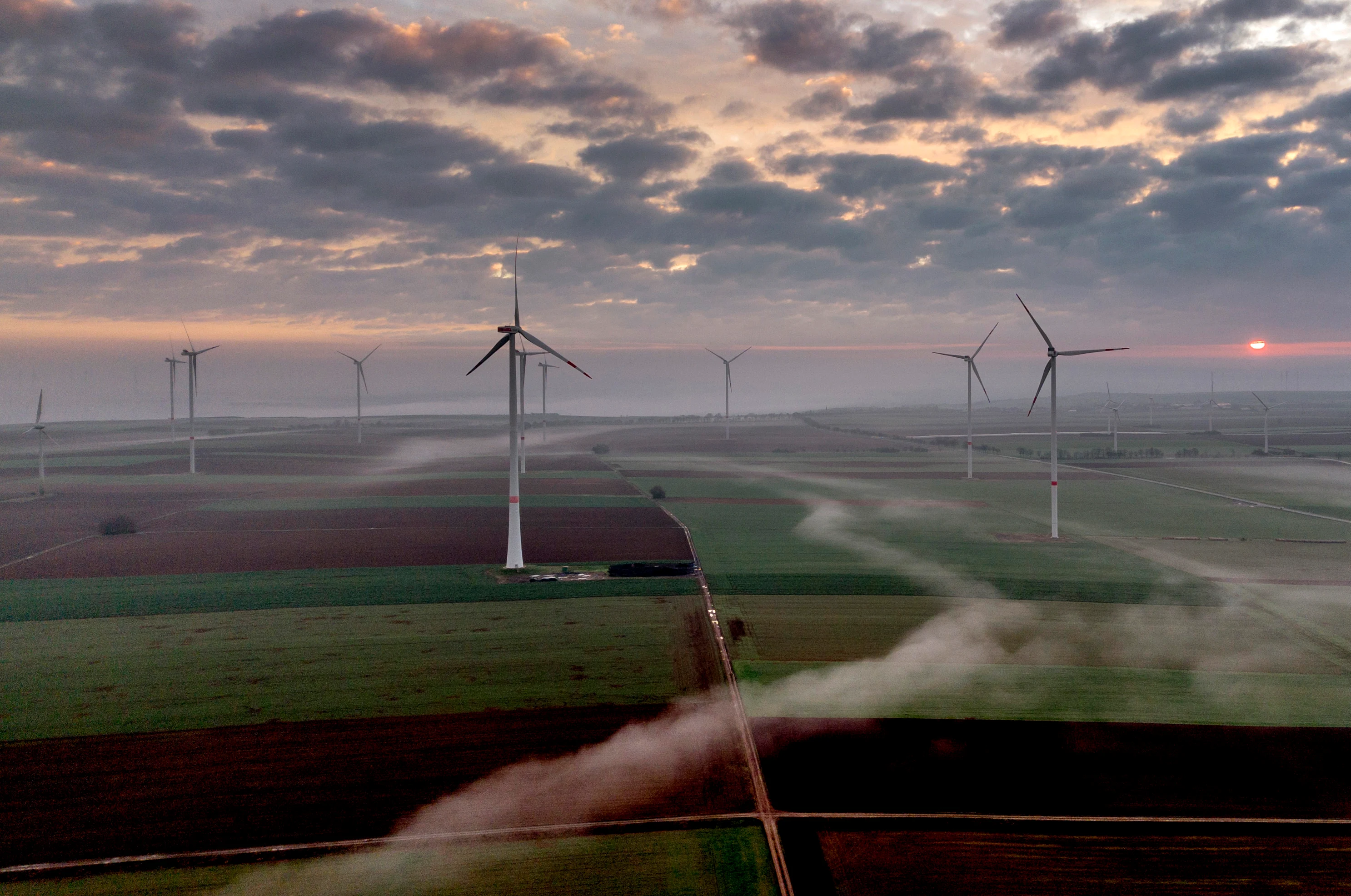 Wind turbines operate at an energy plant.