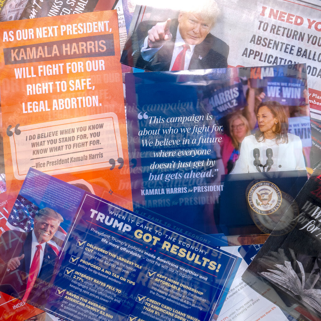 A pile of mailers, some for Trump and some for Harris.