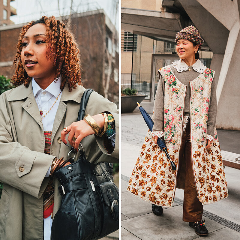 A woman with loose curls and a light olive trench coat, and another with a lace collar and a long, quilted floral gilet.