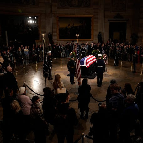 People pay respects as the public gathers and passes by former President Jimmy Carter in the Rotunda at the U.S. Capitol on Jan. 7, 2025 in Washington, DC. Carter's body will lie in state in the Capitol Rotunda until a funeral service at the National Cathedral in Washington on January 9.