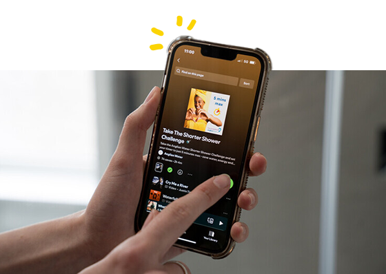 A phone showing an image of 'Take the shorter shower challenge' on screen