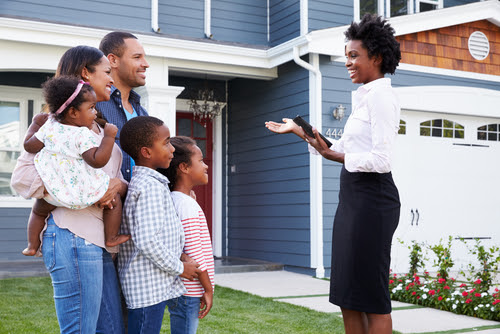 Real estate agent showing a family a house_ closer in