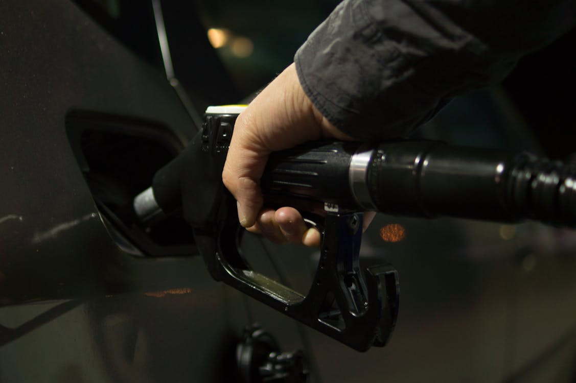 Free Person Holding Gasoline Nozzle Stock Photo