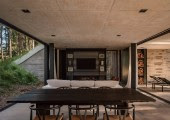 El interior de la vivienda está diseñado con una paleta de materiales que dialoga con el entorno: piedra líquida, madera, hierro y vidrio.
