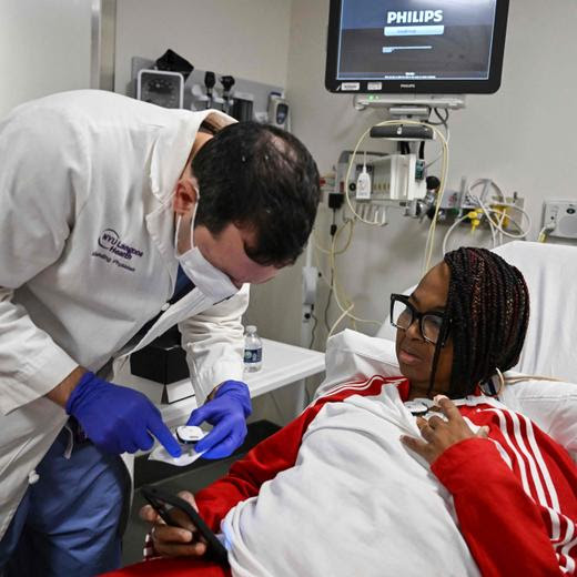 Towana Looney, 53, who received a gene-edited pig kidney undergoes medical testing with Dr. Jeffrey Stern, MD at NYU Langone Health on December 11, 2024 in New York. On a farm in the southern US state of Virginia, David Ayares and his research teams are breeding genetically modified pigs to transplant their organs into human patients. Revivicor, the biotech company Ayares leads, is at the forefront of xenotransplantation research -- the implantation of animal organs into humans -- which aims to solve a chronic organ shortage that has thousands of Americans dying each year. It was on this farm that Revivicor bred a pig whose kidney was recently transplanted into patient Towana Looney, according to an announcement made December 17, 2024 by a New York hospital. (Photo by ANGELA WEISS / AFP)