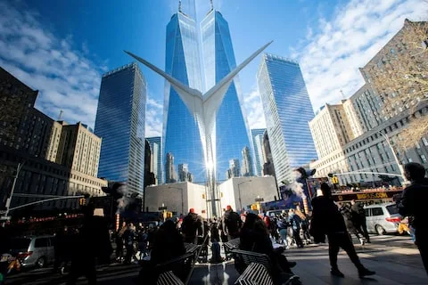 People walk around the Financial District near the New York Stock Exchange