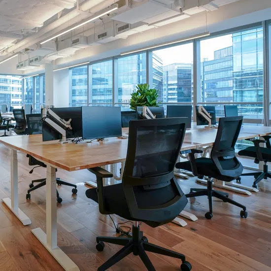 Modern collaborative workspace with ergonomic chairs and sit-stand desks