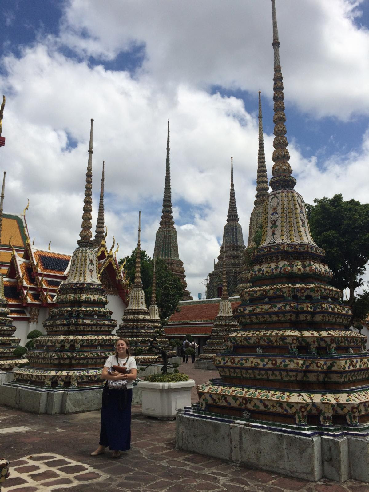 Student smiling in front of Wat Pho