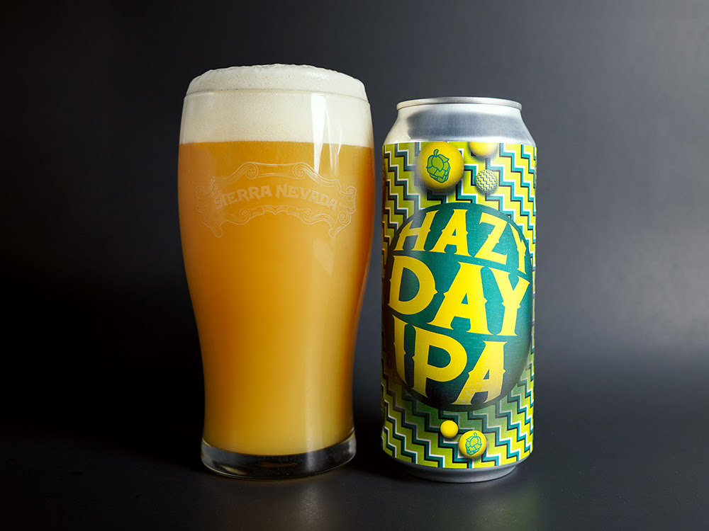 A full glass and can of the Sierra Nevada and Omnipollo collaboration Hazy Day IPA