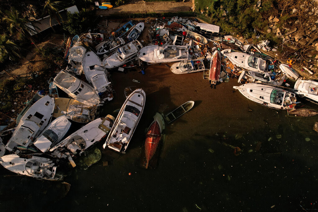 An aerial view of boats piled aground at the shoreline. 