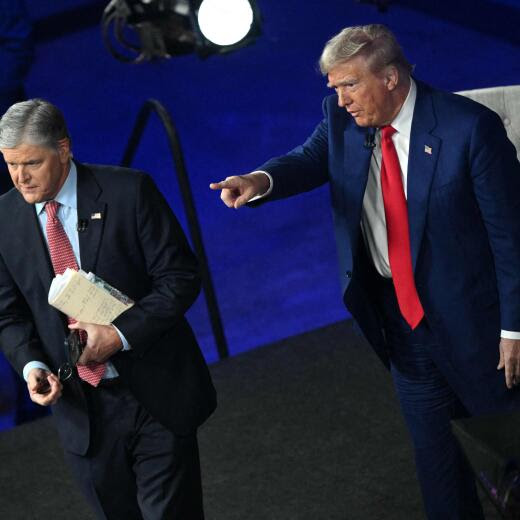 Former US President and Republican presidential candidate Donald Trump (R) points to an audience member alongside Fox News broadcaster Sean Hannity at the end of a town hall at the New Holland Arena in Harrisburg, Pennsylvania, on September 4, 2024. (Photo by Mandel NGAN / AFP)