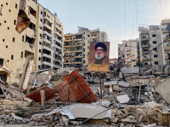 TOPSHOT - -- AFP PICTURES OF THE YEAR 2024 -- A portrait of slain Hezbollah leader Hassan Nasrallah sits amidst debris in the Rouweiss neighbourhood of Beirut's southern suburb on October 10, 2024, following overnight Israeli strikes.. The United States urged its ally Israel to avoid Gaza-like military action in Lebanon, after Prime Minister Benjamin Netanyahu said it could face "destruction" like the Palestinian territory. (Photo by AFP) / AFP PICTURES OF THE YEAR 2024