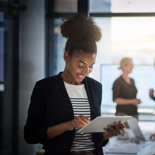 Woman standing working from her tablet