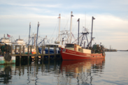 Ships docked in Point Judith at sunset on calm waters