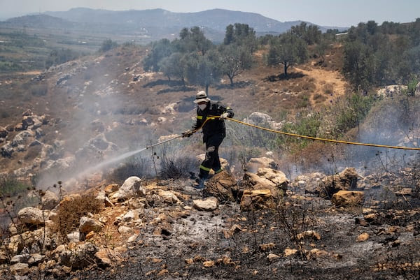 Fireman Anis Abla tackling a wildfire in the hills near Marjayoun, south Lebanon, in July. Matt Kynaston for The National