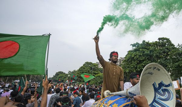 Students and other activists carry Bangladesh's national flag during a protest march organized by Students Against Discrimination to mark one month since former Prime Minister Sheikh Hasina stepped down after a mass uprising, in Dhaka, Bangladesh, Thursday, Sept. 5, 2024. (AP Photo/Rajib Dhar) **FILE**