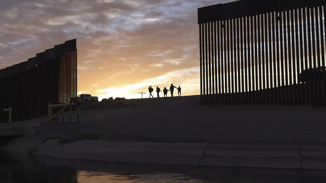  A pair of migrant families from Brazil seeking asylum, walk through a gap in the border wall to reach the United States after crossing from Mexico to Yuma, Ariz., June 10, 2021. - Sputnik International, 1920, 27.02.2025