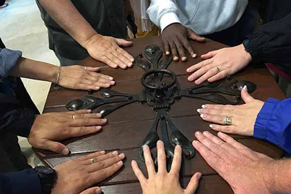 various hands placed on table