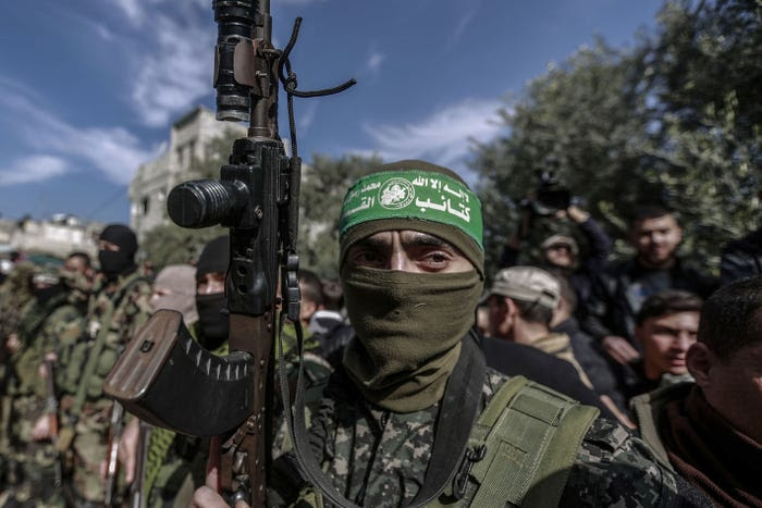 A Hamas militant holds up a rifle at the funeral of a fellow fighter in 2019.