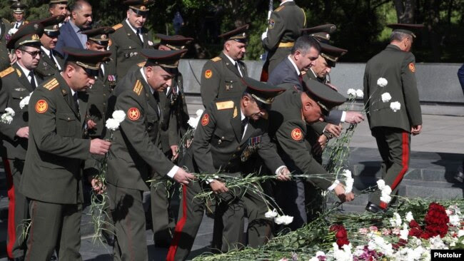 Armenia - Armenian military officials lay flowers at a World War II memorial in Yerevan, May 9, 2025.