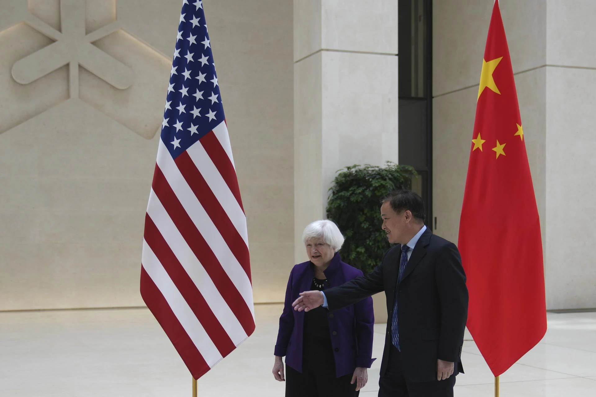 U.S. Treasury Secretary Janet Yellen walks with Governor of the People's Bank of China Pan Gongsheng.