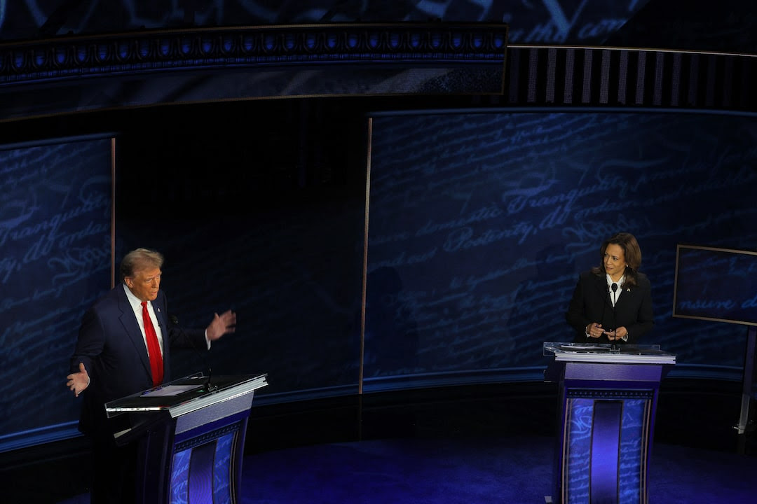 Republican presidential nominee, former President Donald Trump speaks as Democratic presidential nominee, Vice President Kamala Harris listens as they attend a presidential debate hosted by ABC in Philadelphia, Pennsylvania.