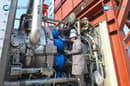 Workers looking over Jupiter One's combustion chambers