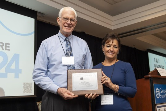 Rick DeVries, Asst. City Engineer of Grand Rapids, receives the TAMC Carmine Palombo Individual Achievement Award from TAMC Chair, Joanna Johnson. 