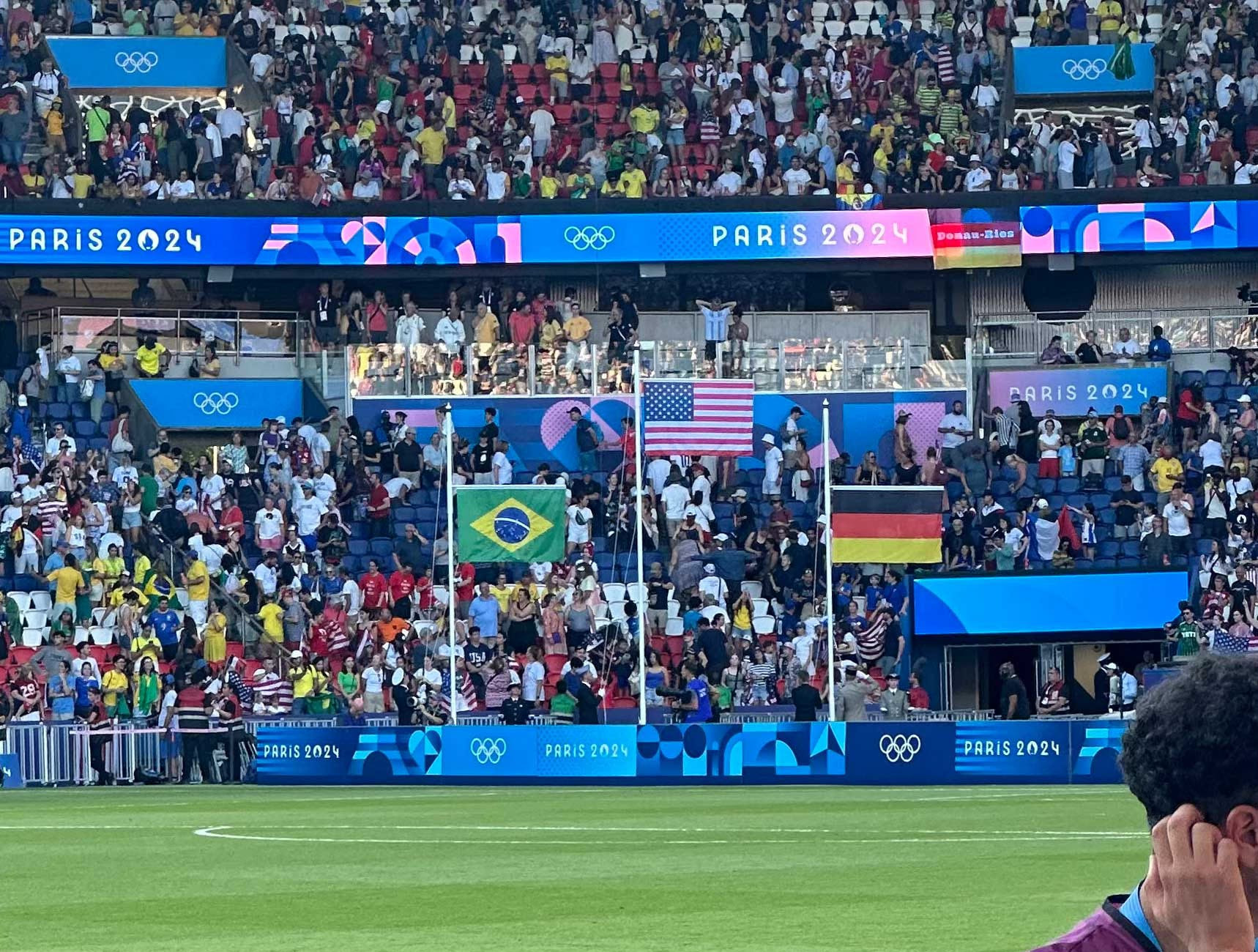 Flags of the United States, Brazil and Germany raised following the soccer match.