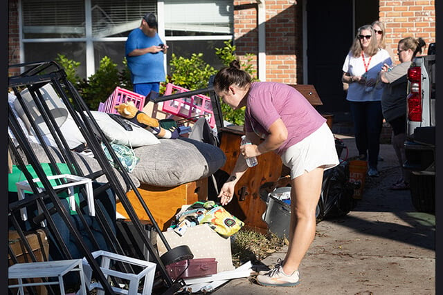 Mary Allen looks through household items ruined by floodwaters from Hurricane Helene at her home in the Shore Acres neighborhood of St. Petersburg, Fla. Photo by Mike DuBose, UM News.