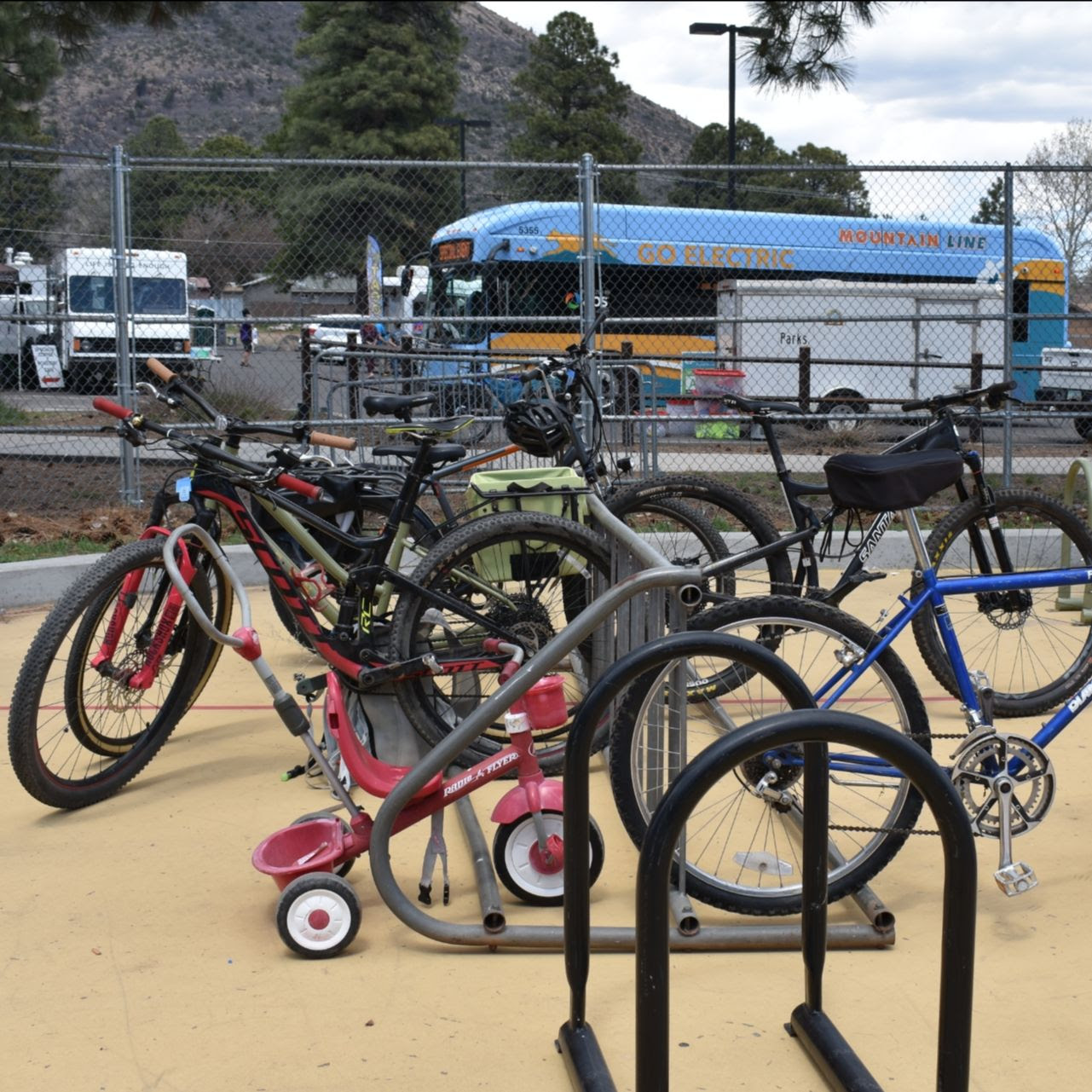 a row of bikes parked at a bike rack