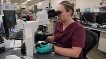 woman using microscope