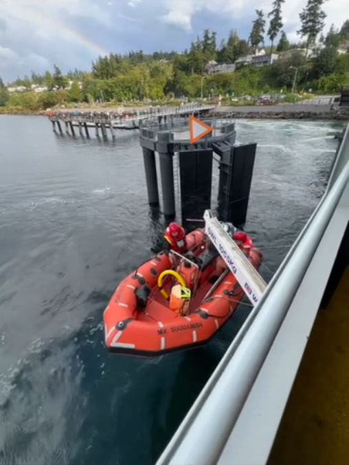 Rescue boat being lowered from a ferry docked at Mukilteo terminal