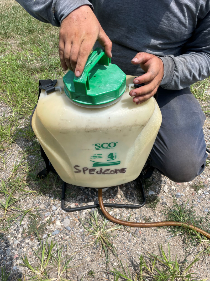 Person holding a container with pesticide fluid