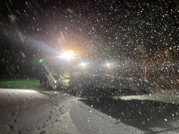 A WSDOT plow clears a road during heavy snow