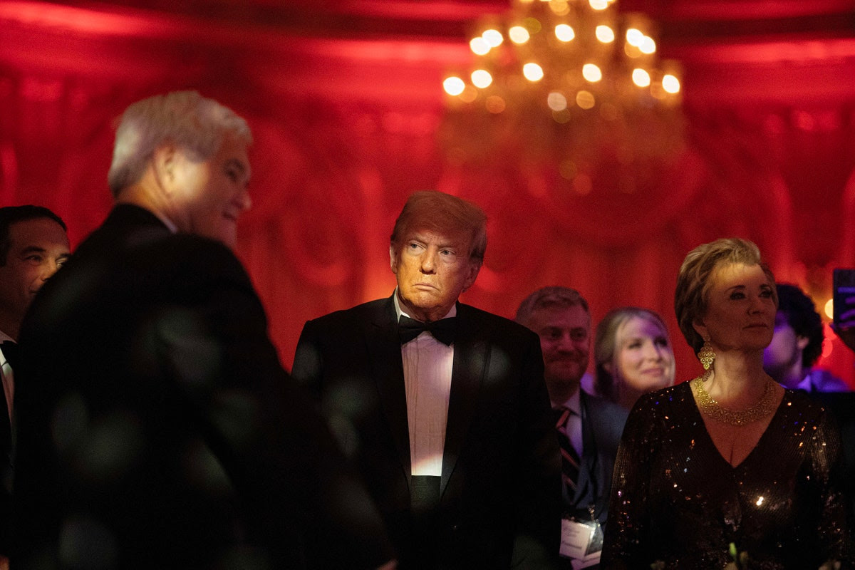 Donald Trump in a tux at a crowded event.